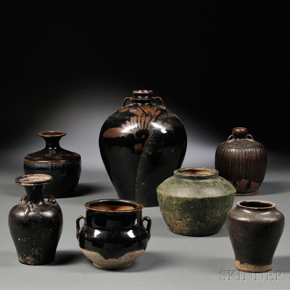 Appraisal: Seven Glazed Pottery Jars China a Henan-style black-glazed jar with