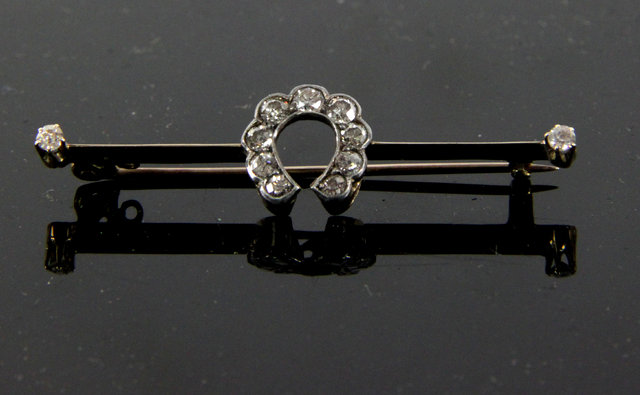 Appraisal: A diamond horseshoe brooch the horseshoe set nine stones on