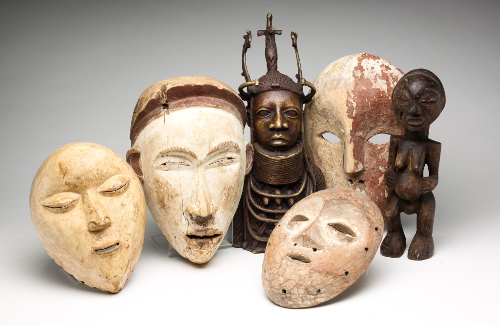 Appraisal: Twentieth century Four carved wooden masks Two with layers of