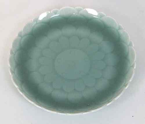 Appraisal: A Chinese celadon dish moulded as a lotus bloom bearing