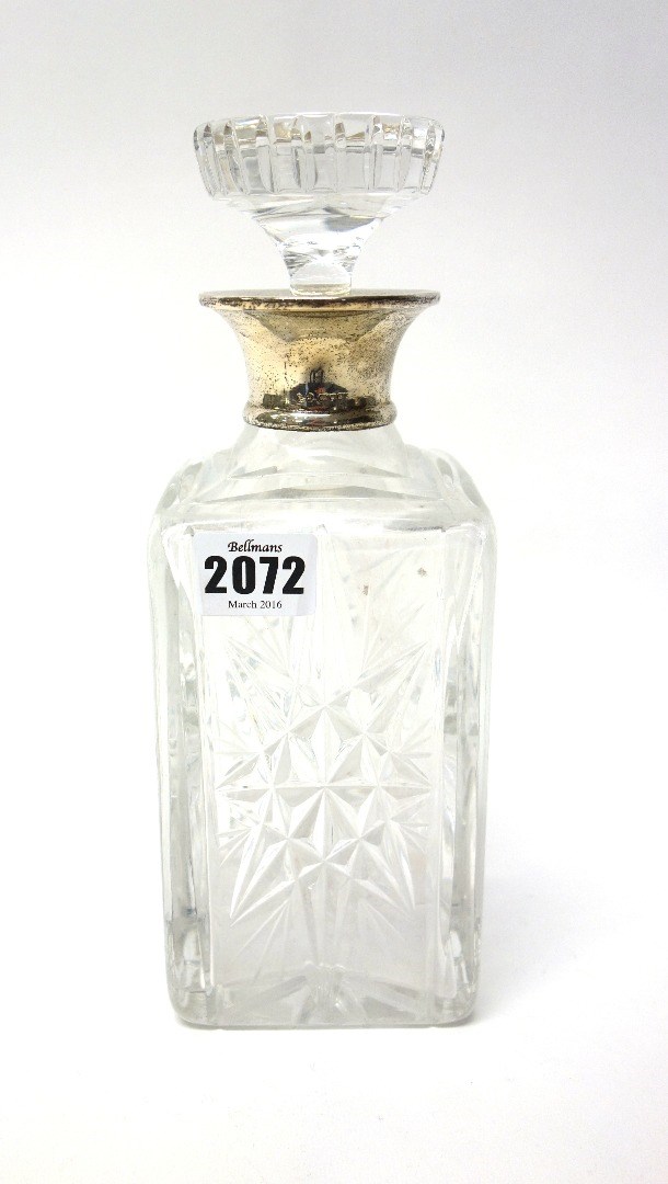 Appraisal: A silver mounted glass decanter of square section form with