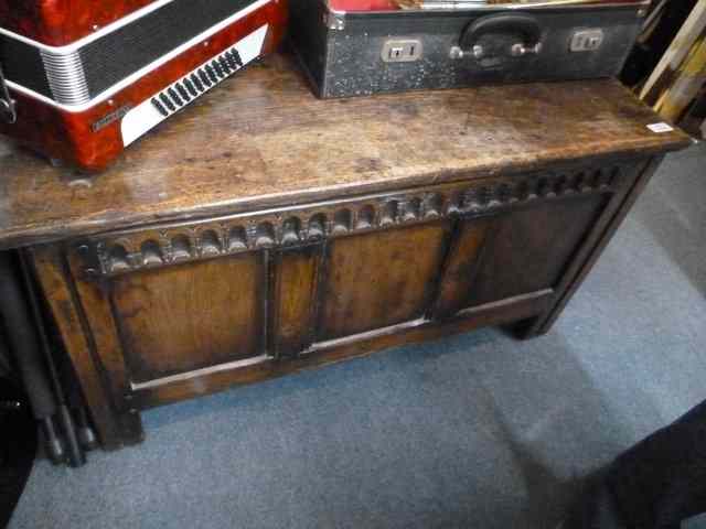 Appraisal: AN ANTIQUE OAK COFFER with triple panelled front standing on