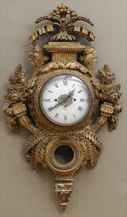 Appraisal: LOUIS XVI CARVED GILTWOOD CARTEL CLOCK The in enamel dial