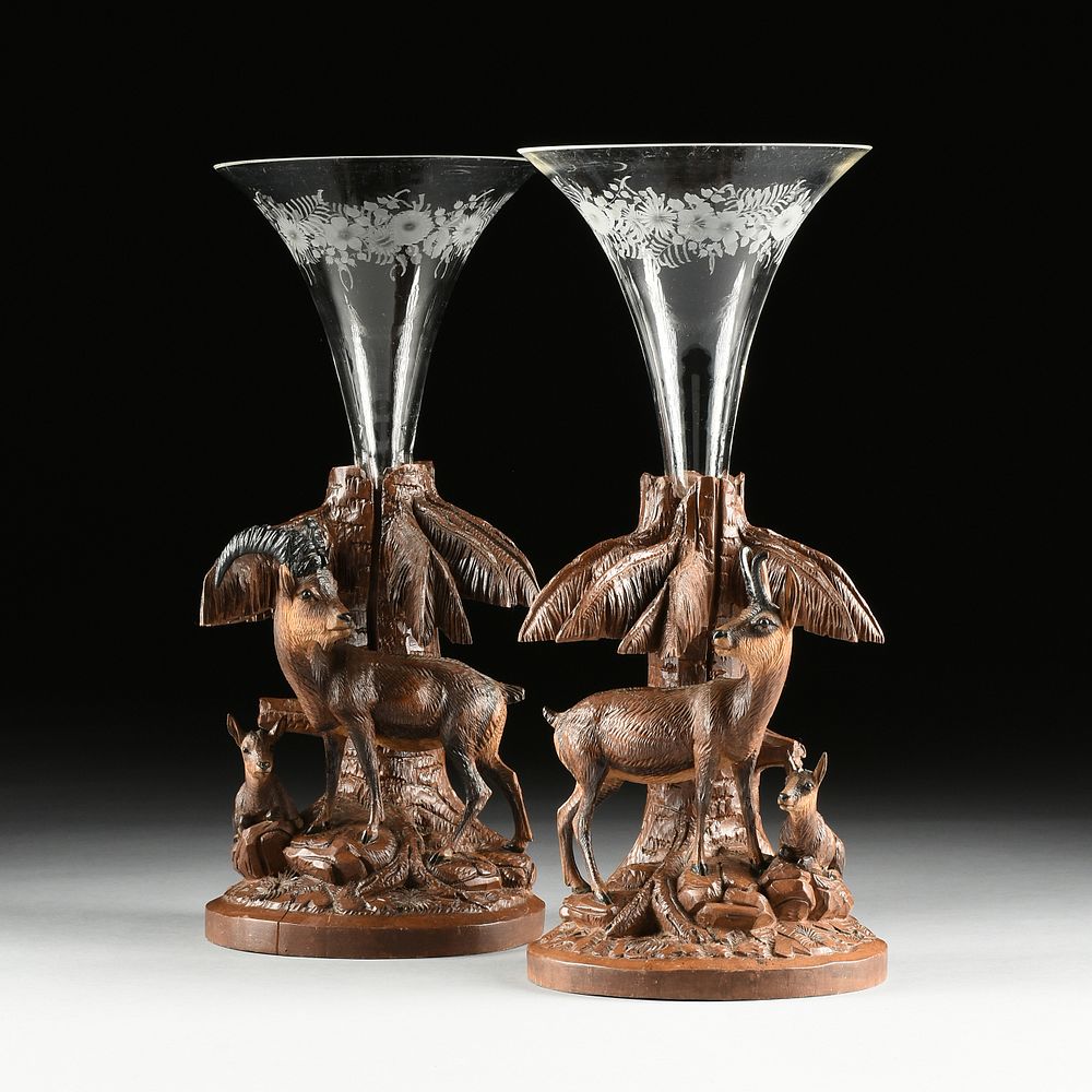 Appraisal: A PAIR OF BLACK FOREST FIGURAL CARVED WALNUT AND GLASS