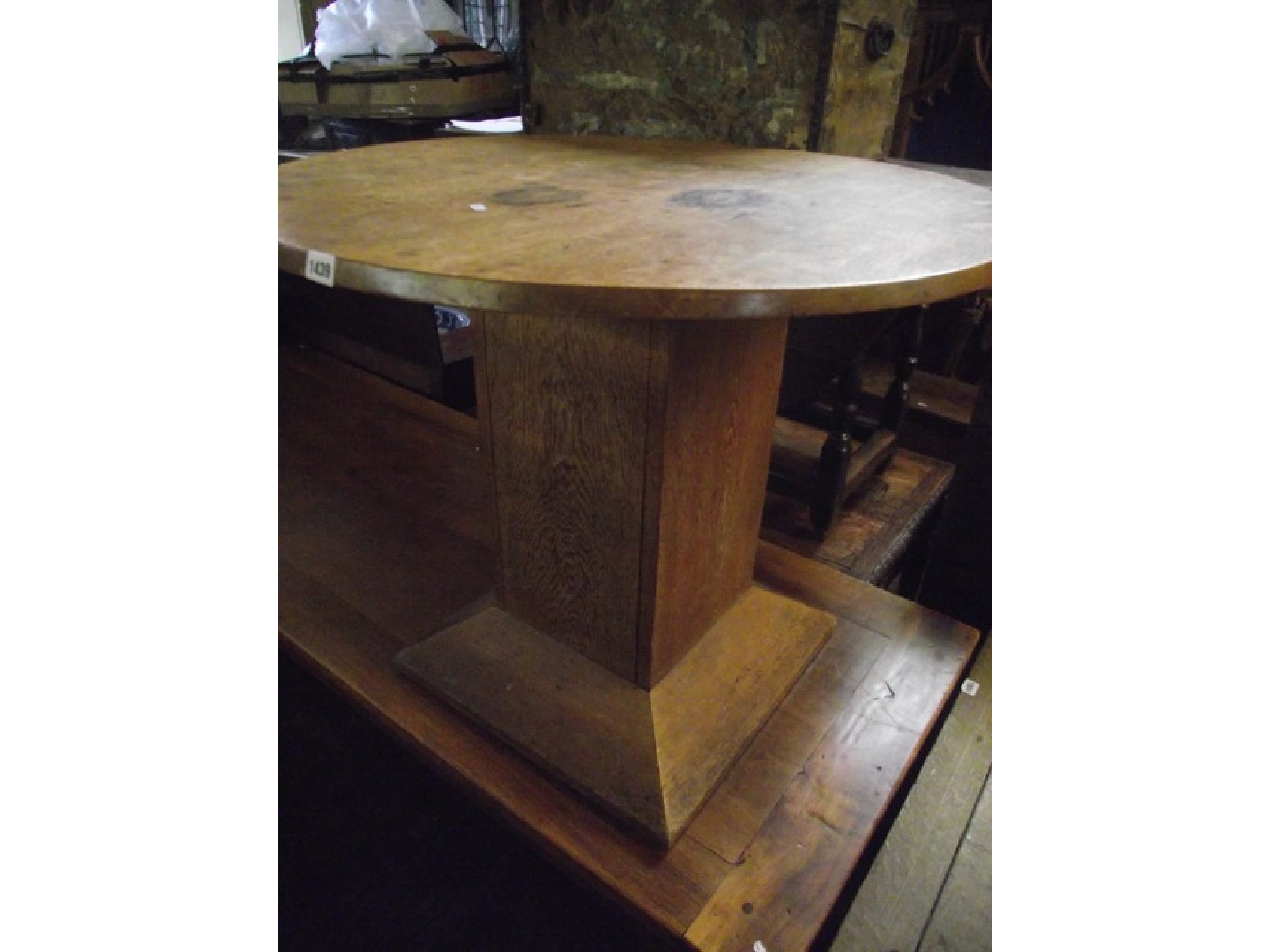 Appraisal: A fumed oak centre occasional table of circular form raised