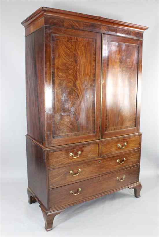 Appraisal: A George III mahogany linen press with panelled doors over