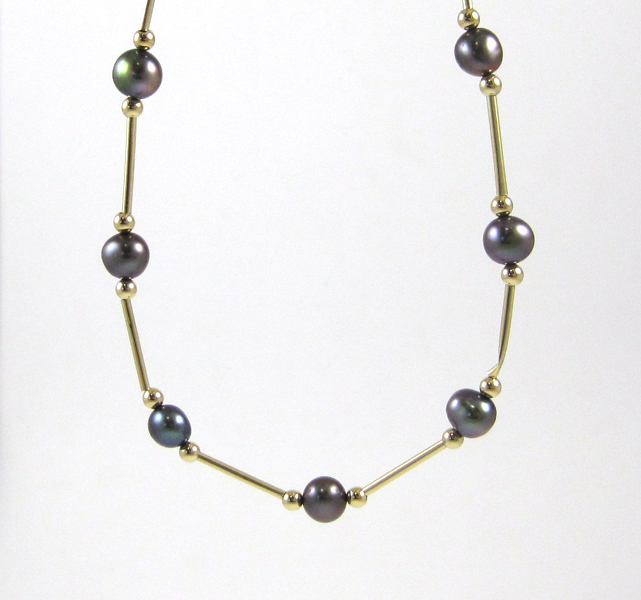 Appraisal: BLACK PEARL AND FOURTEEN KARAT GOLD NECKLACE measuring inches in