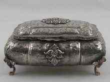 Appraisal: A silver rectangular bombe casket on four feet heavily chased