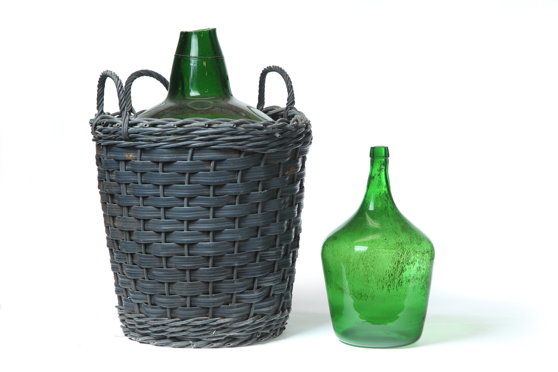 Appraisal: TWO CONTINENTAL DEMI JOHNS Twentieth century Green glass in baskets