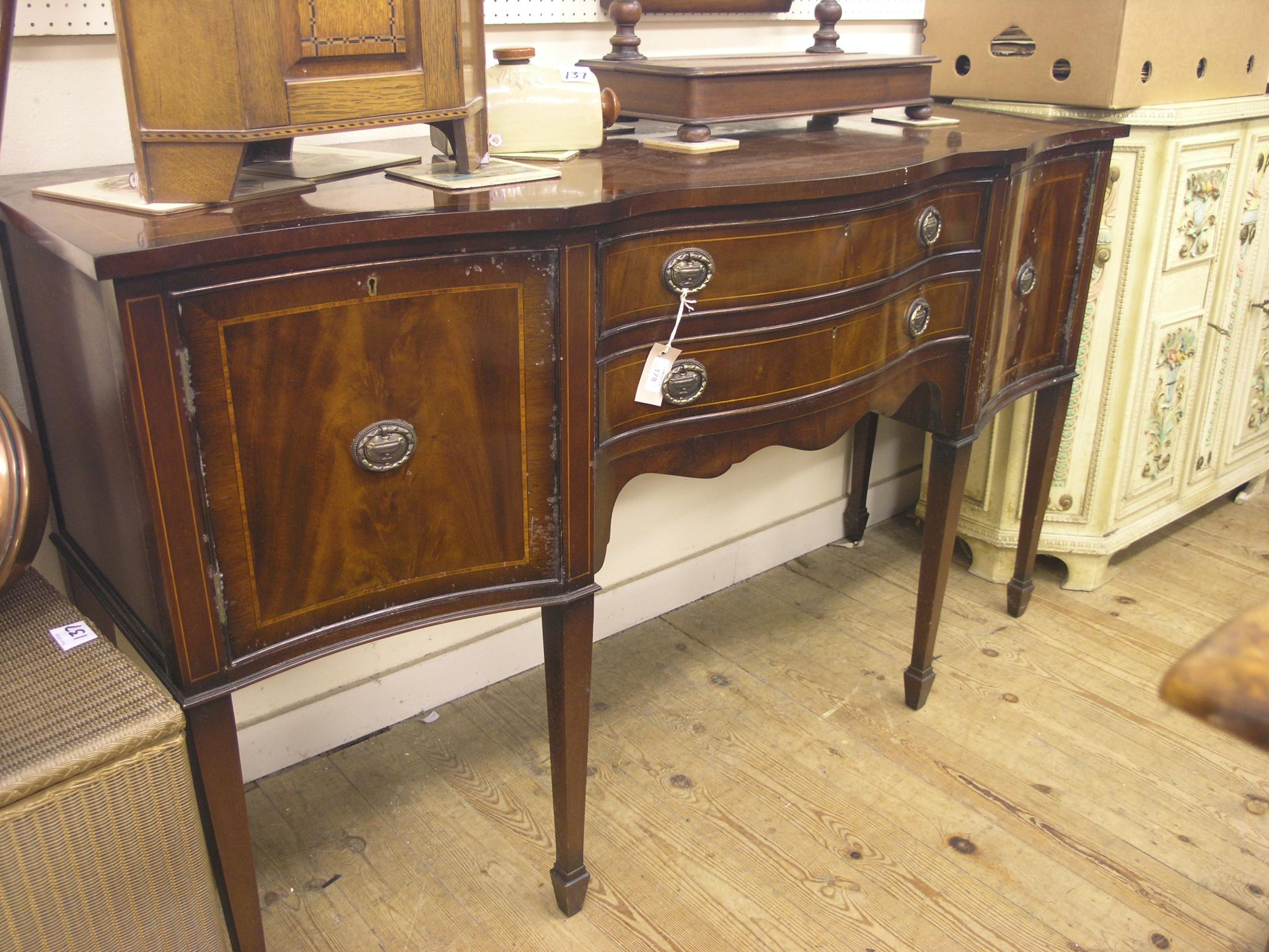 Appraisal: A reproduction mahogany sideboard serpentine-fronted with two drawers and two