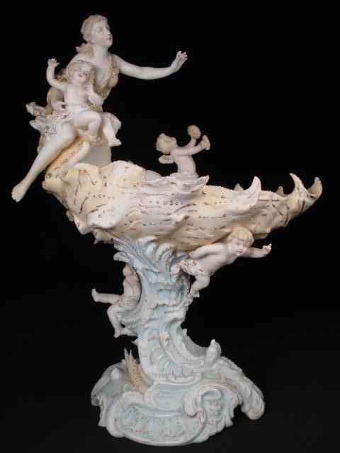 Appraisal: German Bisque figurine of a woman with cupids on a