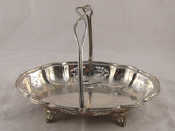 Appraisal: A late Victorian silver cake basket on scroll acanthus feet