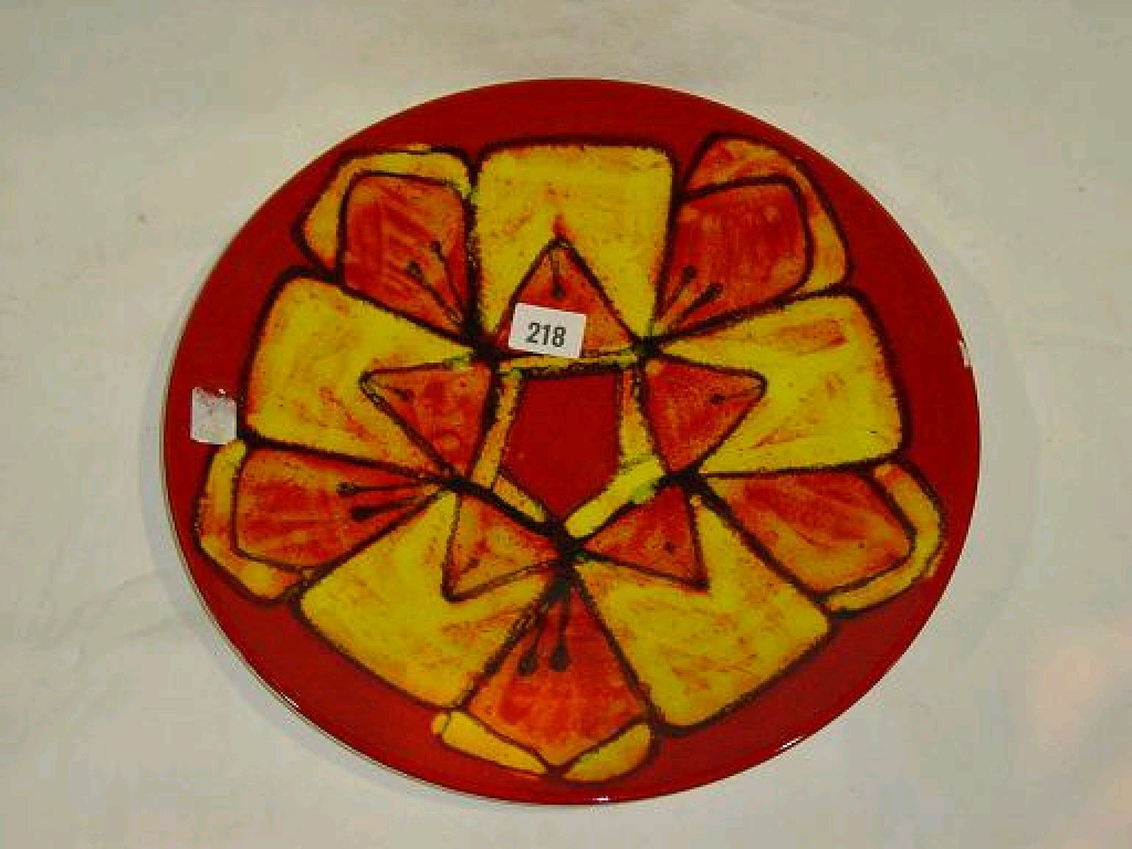 Appraisal: A dark orange ground Poole Pottery charger with abstract style