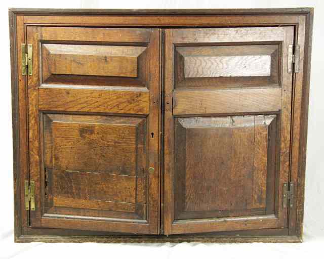 Appraisal: An early th Century oak hanging cupboard enclosed by a