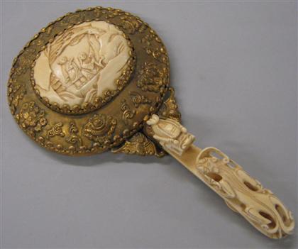 Appraisal: Chinese elephant ivory and brass hand mirrorThe oval hand mirror