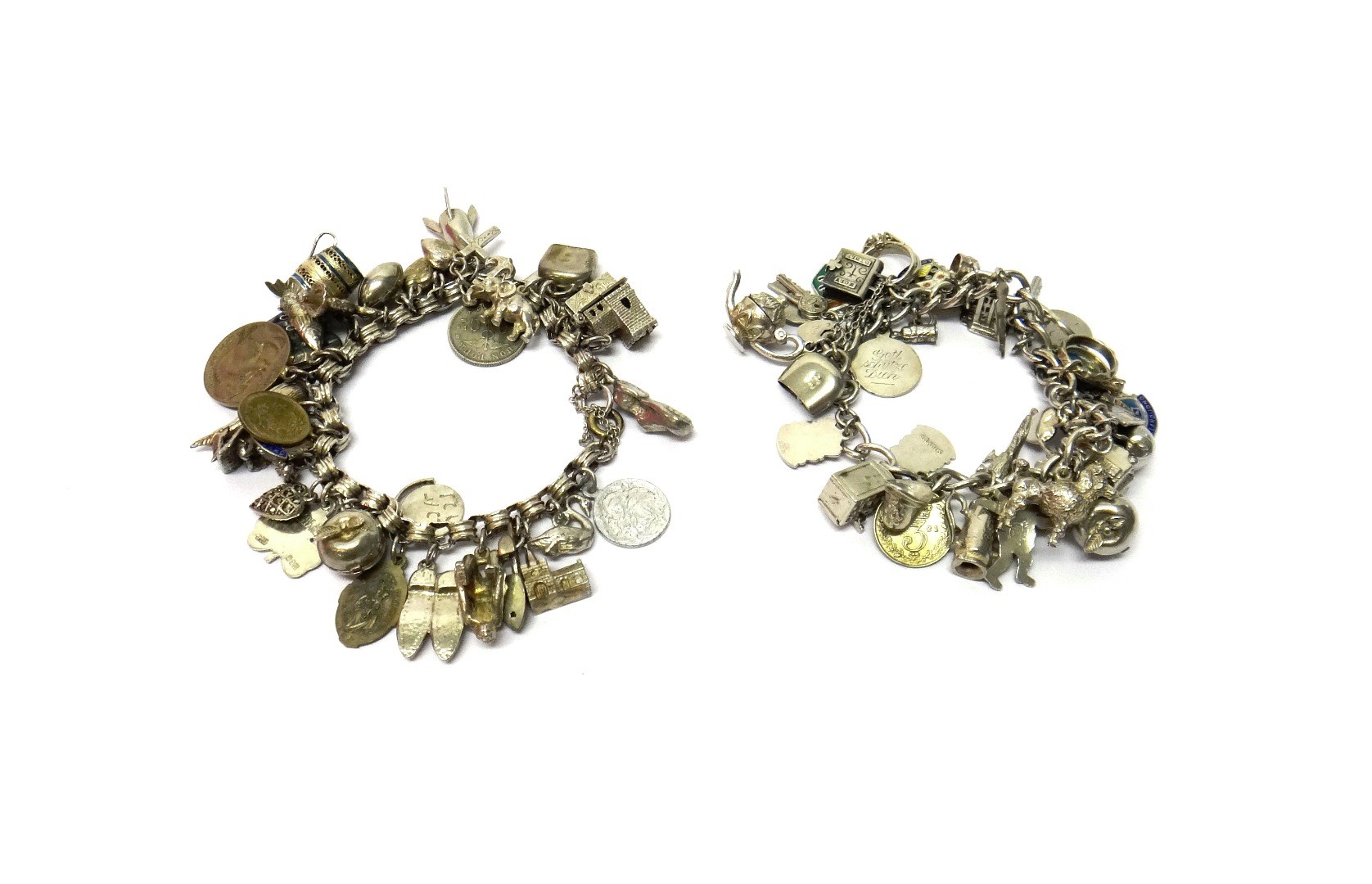 Appraisal: Two charm bracelets each fitted with a variety of mostly