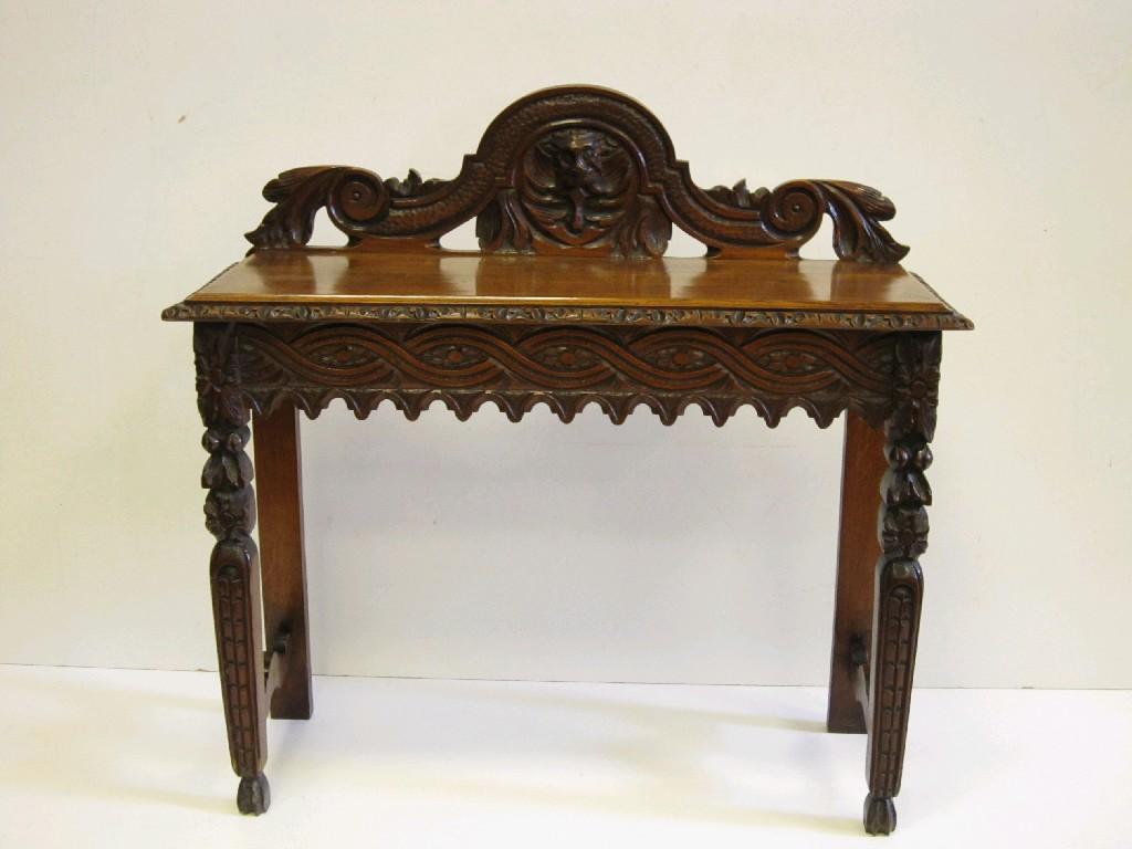 Appraisal: A Victorian oak Hall Table with mask carved raised back