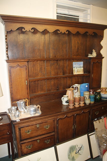 Appraisal: A VICTORIAN OAK DRESSER with raised back and enclosed base