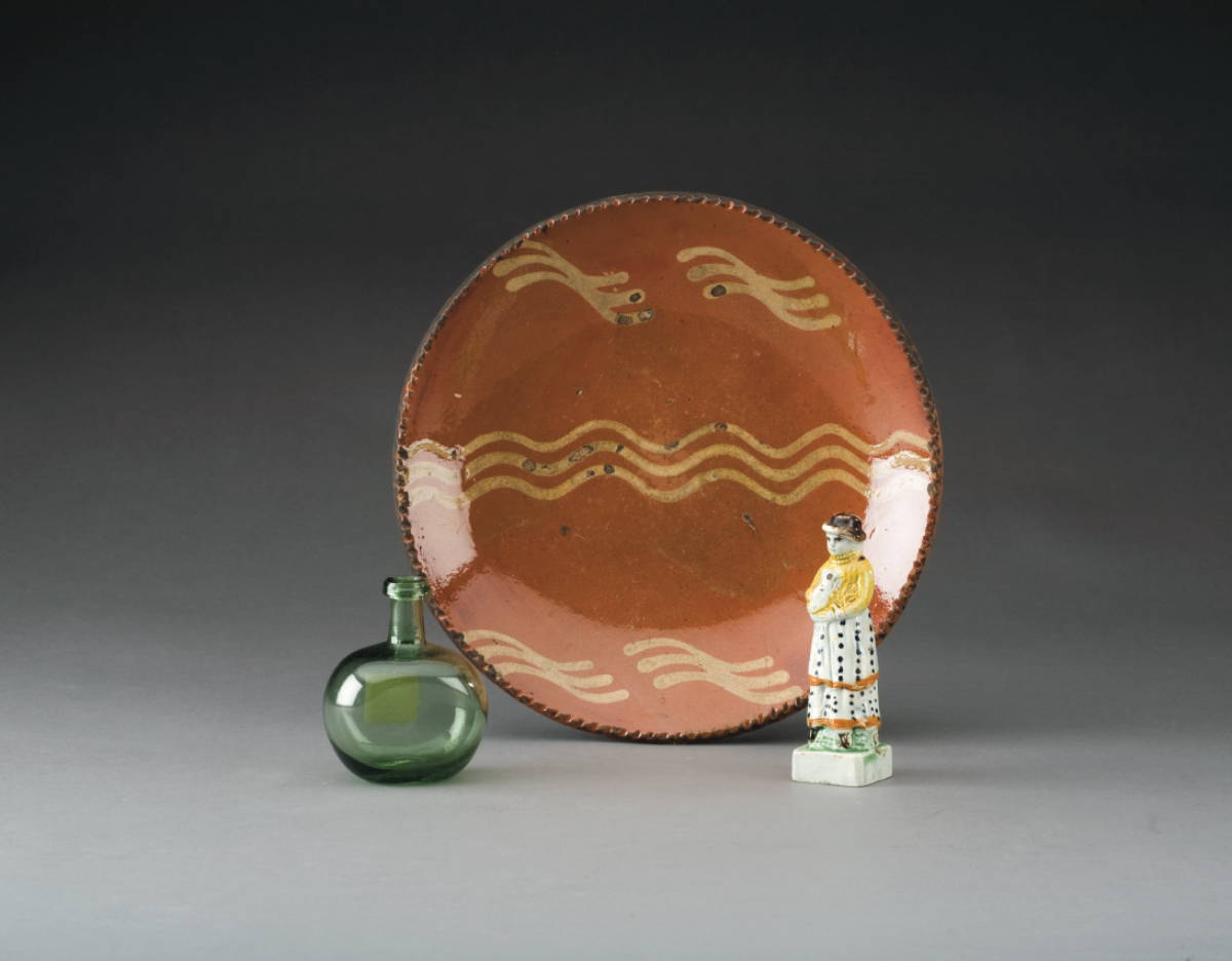 Appraisal: NEW ENGLAND SLIP-DECORATED REDWARE PLATE A SMALL CHESTNUT BOTTLE AND