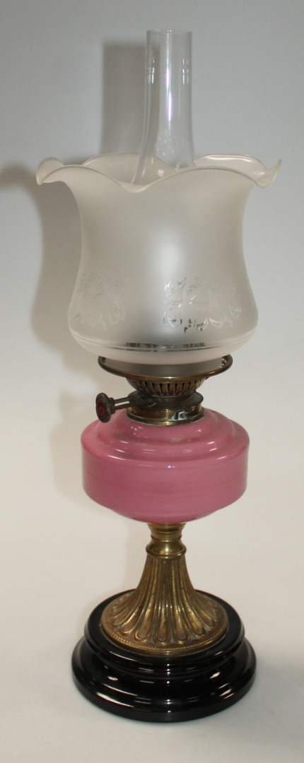 Appraisal: An Edwardian brass oil lamp with clear glass funnel and