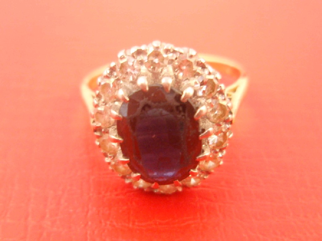 Appraisal: A sapphire and diamond cluster dress ring central oval stone