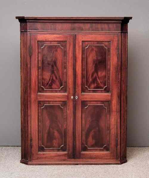 Appraisal: A George III mahogany hanging corner cupboard with moulded cornice