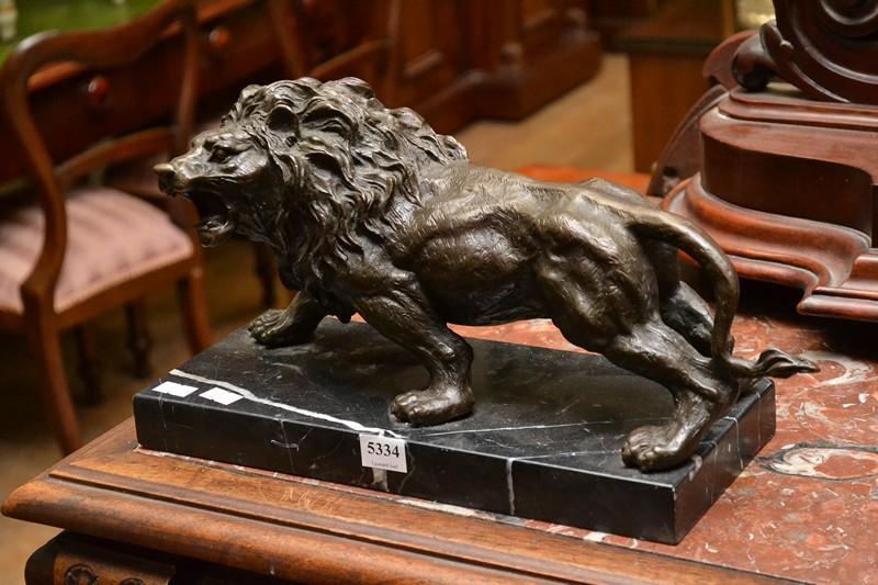 Appraisal: A BRONZE LION STATUE ON MARBLE BASE A BRONZE LION