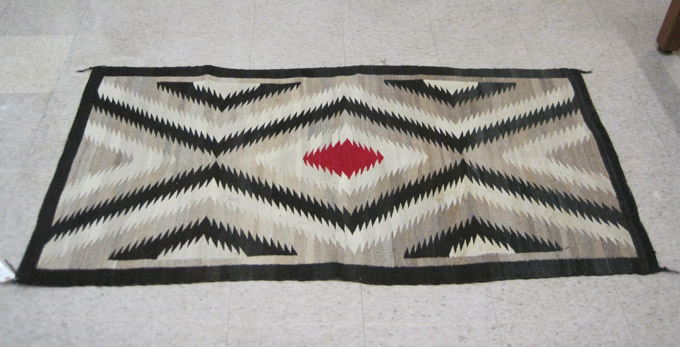 Appraisal: HAND WOVEN NAVAJO RUG eye dazzler lightning pattern centering a