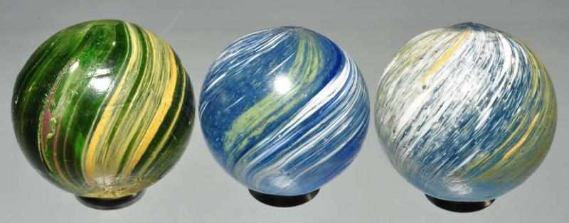 Appraisal: Lot of Banded Transparent Marbles Description Smallest marble is a