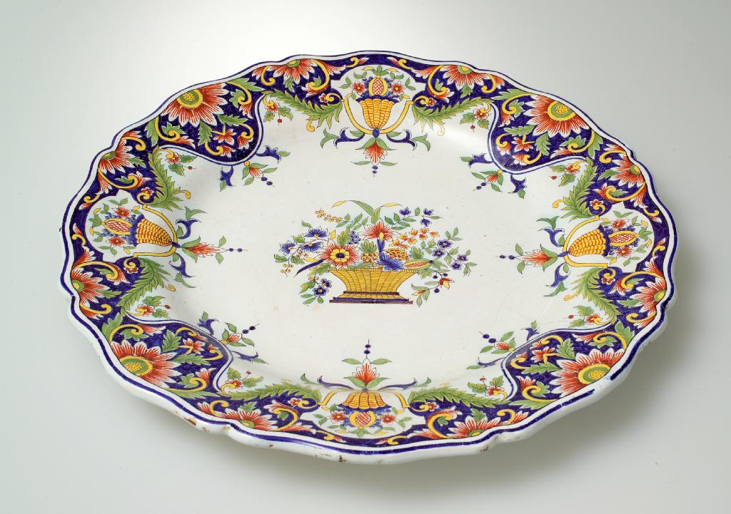 Appraisal: th CENTURY FAIENCE POLYCHROME CHARGER IN ROUEN STYLE of shaped