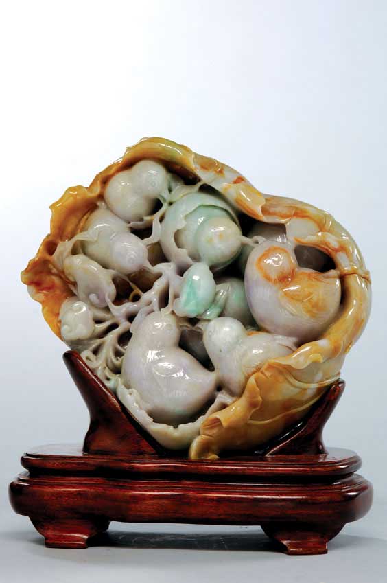 Appraisal: CARVED JADEITE GROUP Well carved and charming Chinese jadeite group