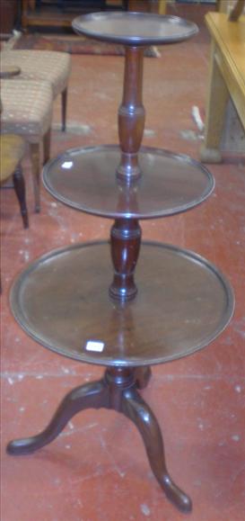 Appraisal: A mahogany three tier circular dumb waiter on tripod base