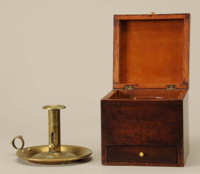 Appraisal: English Tea Caddy Brass Chamberstick Description th Century Mahogany veneered