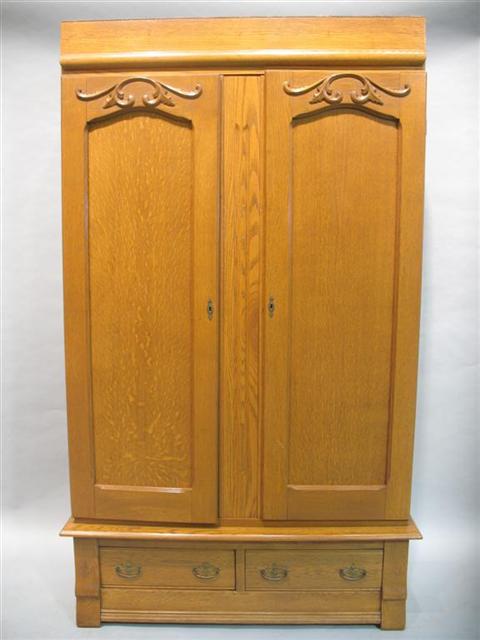 Appraisal: VICTORIAN STYLE OAK PANELED ARMOIRE The plain frieze above pair