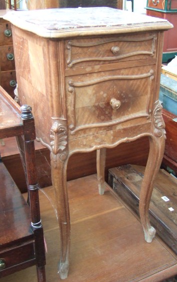 Appraisal: A th century French mahogany bedside table the shaped rouge