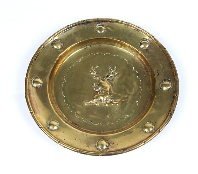 Appraisal: AN ANTIQUE BRASS ALMS DISH the centre embossed with stag