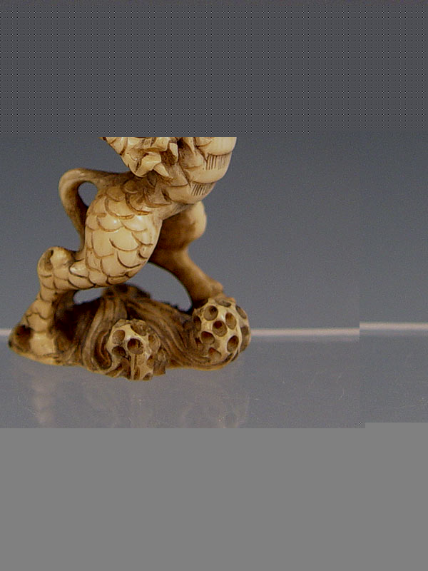 Appraisal: SIGNED JAPANESE CARVED IVORY NETSUKE The Kirin ''