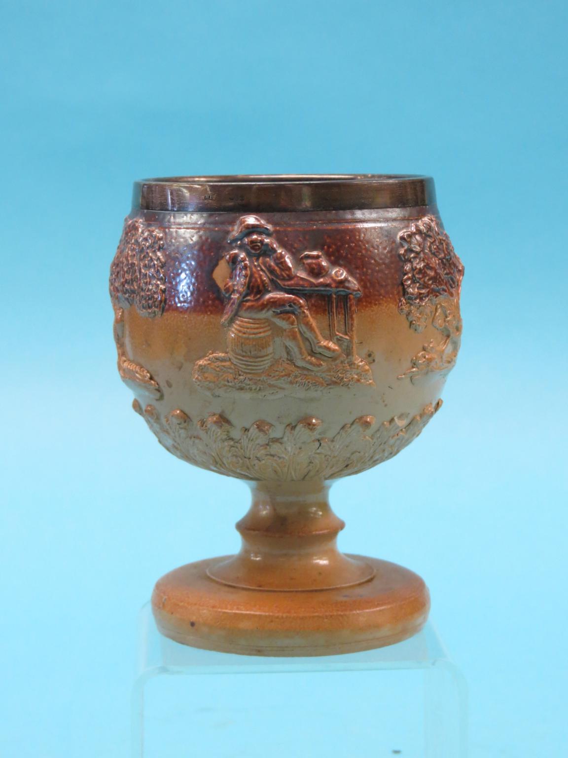 Appraisal: A late Victorian salt-glazed stoneware goblet relief-moulded with seated figures