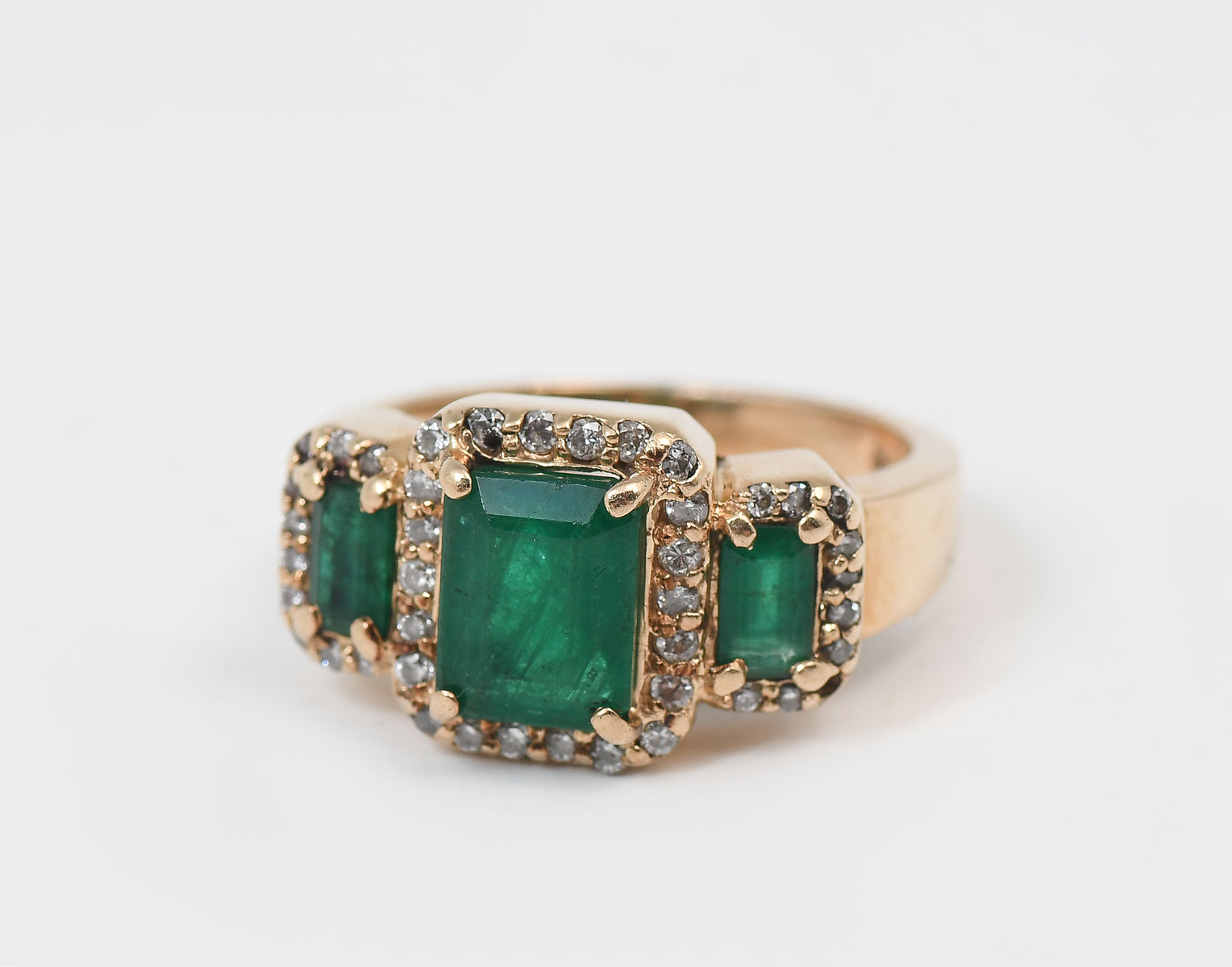 Appraisal: K EMERALD DIAMOND RING K yellow gold ring contains emerald