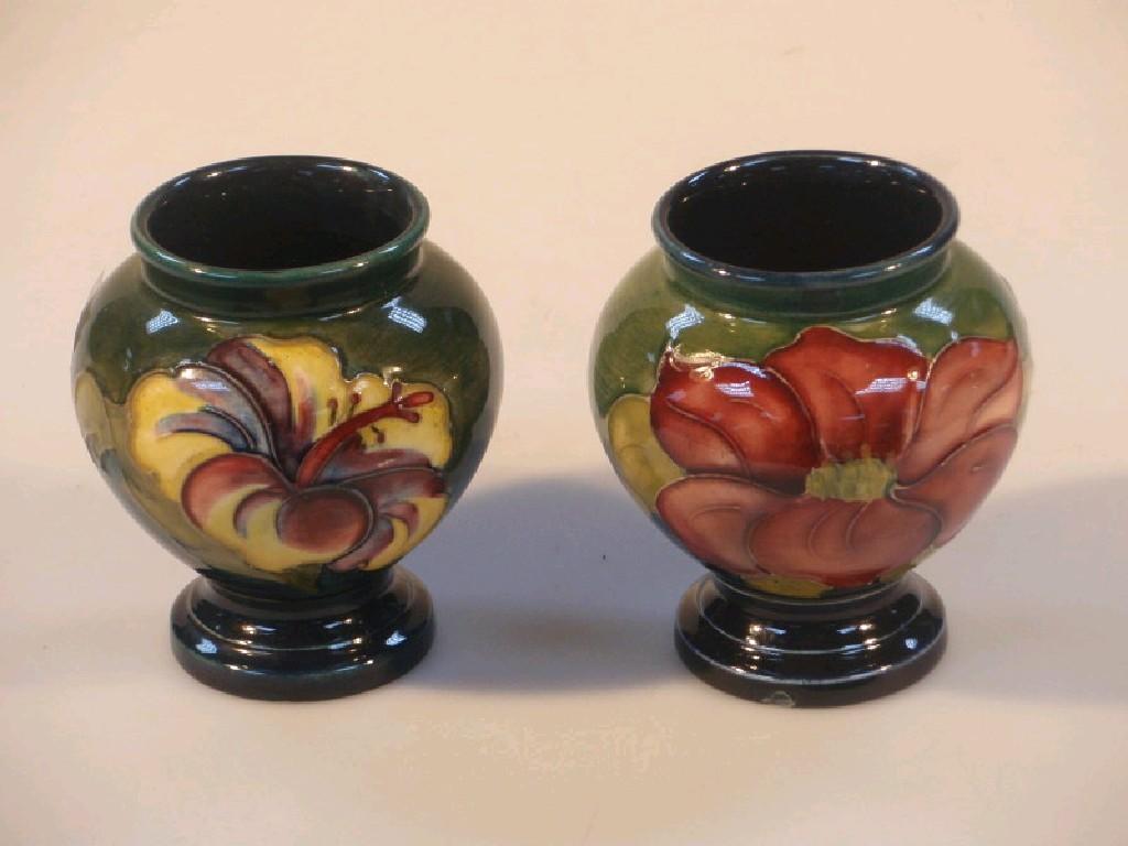 Appraisal: Two small Moorcroft baluster vases decorated with flowers on a