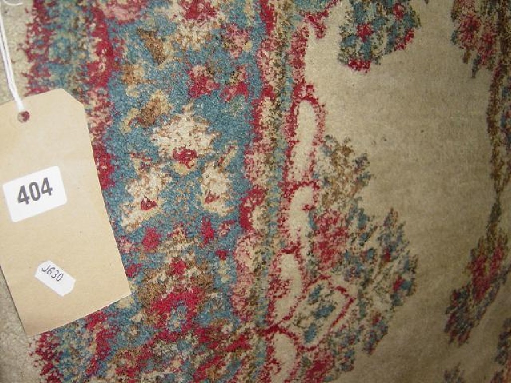 Appraisal: A cream ground wool rug with blue pink and green