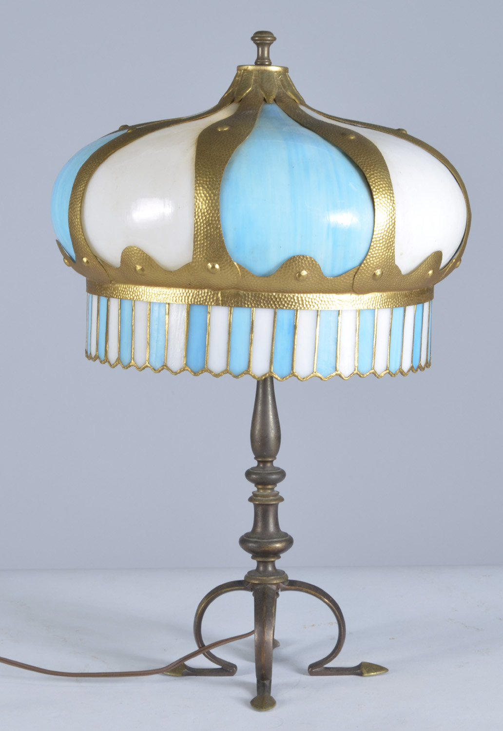 Appraisal: BLUE AND WHITE SLAG GLASS TABLE LAMP with bronze four-footed