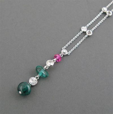 Appraisal: A gemstone pendant the pendant mounted with two emerald beads