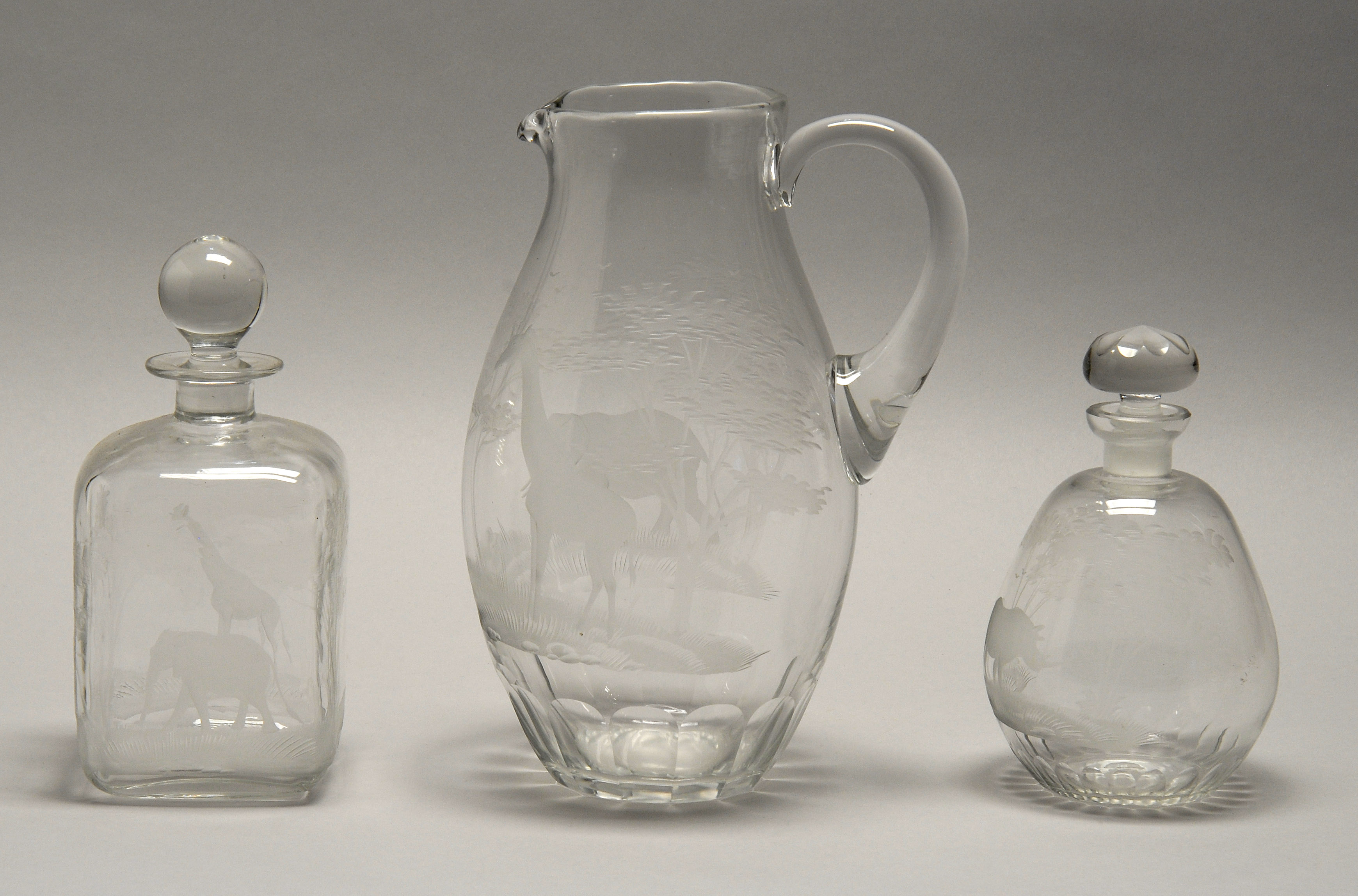 Appraisal: THREE PIECES OF ASSORTED ETCHED GLASS One pitcher and two