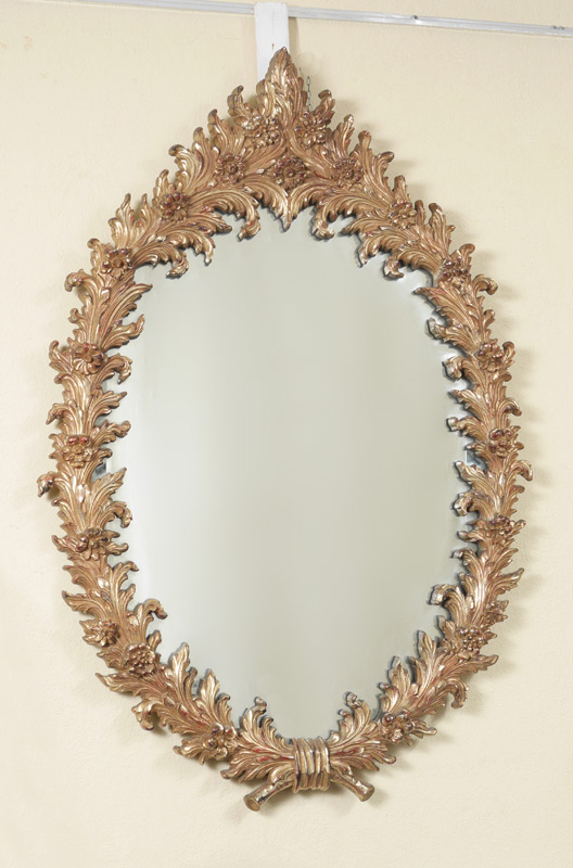 Appraisal: LARGE FLORAL CARVED GILT WALL MIRROR Profusely carved with floral