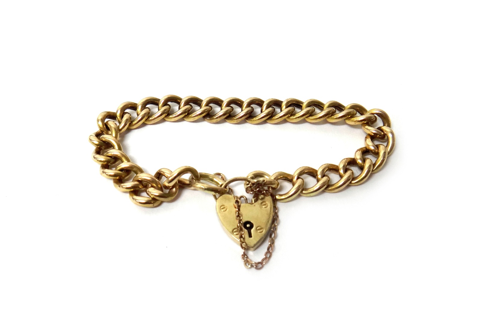 Appraisal: A gold curb link bracelet on a ct gold heart