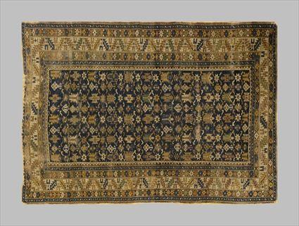 Appraisal: CAUCASIAN RUG The cobalt field with stylized florettes within a