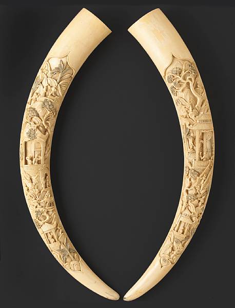 Appraisal: A pair of carved and tinted ivory tusks th Century