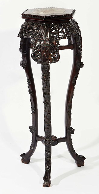 Appraisal: A CHINESE CHERRYWOOD TALL URN STAND with hexagonal top carved