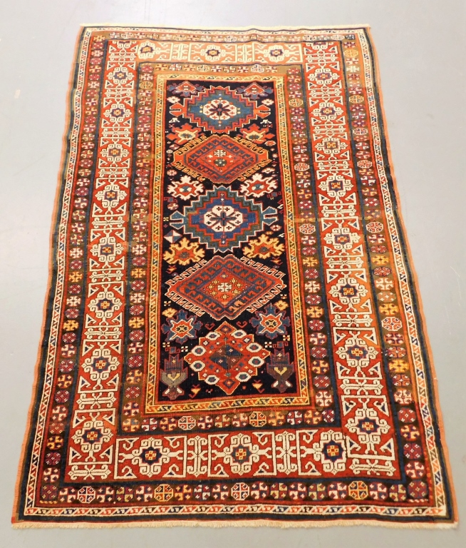 Appraisal: ANTIQUE GEOMETRIC KAZAK CARPET Middle East Circa Red navy blue